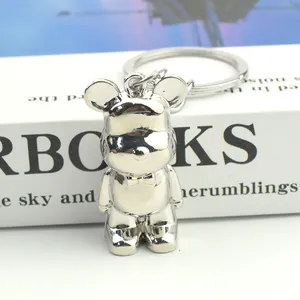 Close-up of silver metal bear keychain with bowtie detail and round ring