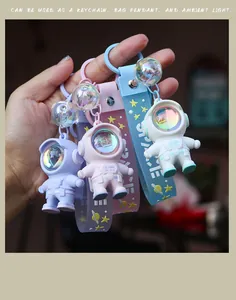 Glow astronaut keychain in blue, pink, and purple silicone with space strap detail