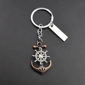 Macro view of vintage bronze anchor keychain with spinning silver ship wheel detail