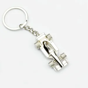 Polished silver metal F1 racing car keychain with realistic details on white background