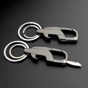 Gunmetal multi-tool keychain with folding blade, bottle opener, and dual key rings