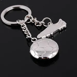 Polished silver metal keychain featuring football and soccer boot charms for sports fans
