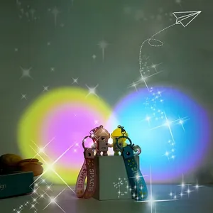 Pink and blue astronaut keychains with LED light and space wristbands on sunset background