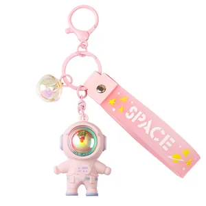 Pink astronaut keychain with glowing face mask, space strap, and bell for women and couples