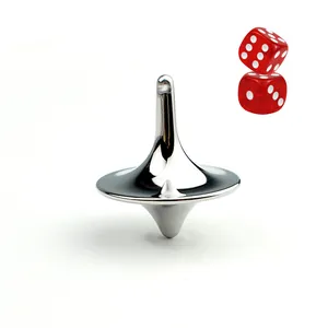 Close-up of a polished silver metal spinning top with red dice on a white background