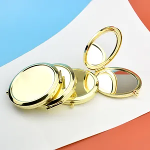 Detailed view of round rose gold folding makeup mirrors with dual-sided glass and metal finish