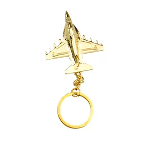 Golden fighter jet airplane keychain in metallic alloy finish on white background