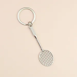 Mini silver badminton racket metal keychain with detailed mesh strings and handle texture
