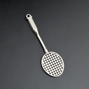 Macro shot of a polished silver mini tennis racket pendant with realistic net texture