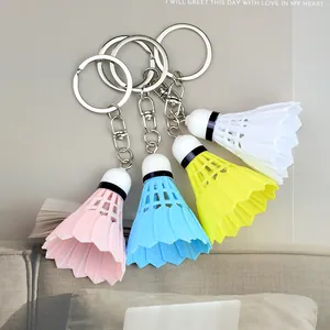 Creative shuttlecock keychains in pink, blue, yellow, and white with metal swivel hooks