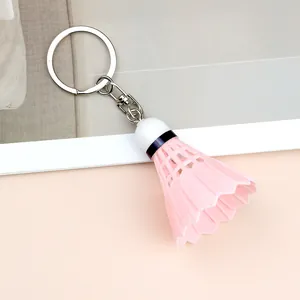 Detailed view of creative pink shuttlecock keychain with a white head and silver metal ring