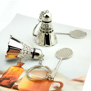 Detailed close-up of a silver metallic badminton and racket combo keychain on a chain