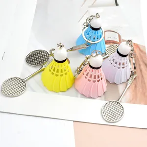 Detailed set of colorful mini badminton racket and shuttlecock keychains in four bright colors