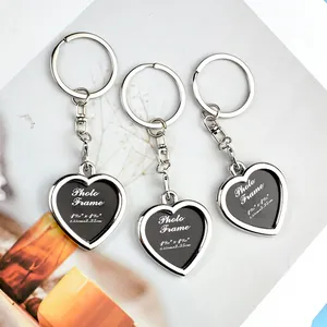 Three heart-shaped metal photo frame keychains with polished silver finish and insert details
