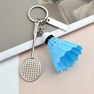 Detail of creative badminton racket keychain with shuttlecock and engraving plate