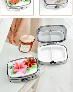 Detail view of portable mini pill box with dual compartments and floral pattern lid