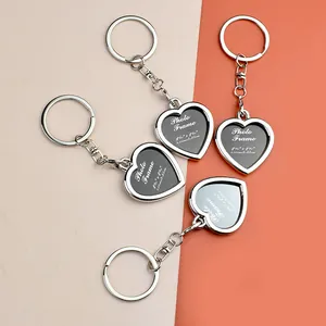 Silver heart-shaped photo frame keychains set for custom pictures on a warm background