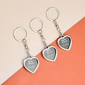 Macro shot of heart shaped photo frame keychains showing dimensions for picture inserts
