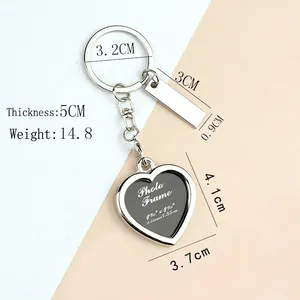 Polished heart shaped photo frame keychain with metal tag on a minimalist background