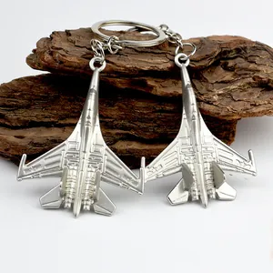Silver metal J-35 fighter jet model keychain with realistic wing and engine details