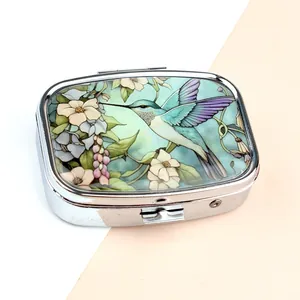 Portable metal pill box with colorful hummingbird and floral print on silver rectangular case