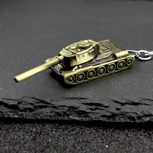 Creative bronze alloy tank model keychain with rotating turret on textured rock background