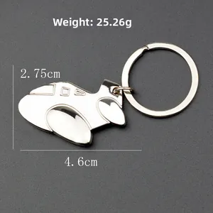 Polished silver alloy airplane model keychain with metal ring on a dark grey background