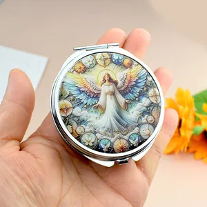 Boîte à pharmacie ronde en métal avec miroir et illustration artistique d'ange