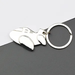 Polished silver aircraft model keychain with detailed windows on a modern background