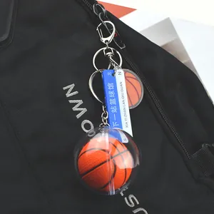 Acrylic basketball keychain featuring a mini 3D model and tag attached to a black backpack