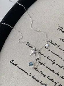 Detail of S925 silver necklace with starfish, shell, pearl and aquamarine charms