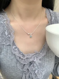 Gros plan du collier étoile en argent S925 avec pierre bleue sur la clavicule
