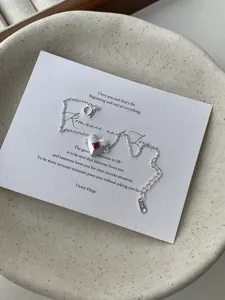 Macro detail of S925 sterling silver heart bracelet with a vibrant red square gemstone