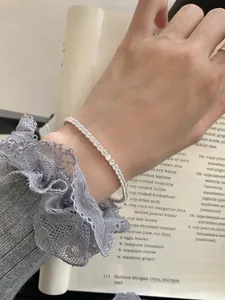 Elegant S925 sterling silver tennis bracelet with sparkling zircons on a model's wrist
