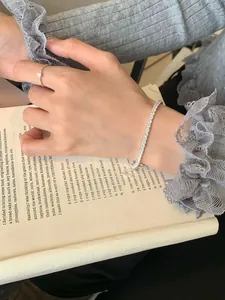 Close-up of sparkling S925 silver tennis bracelet with cubic zirconia on a wrist