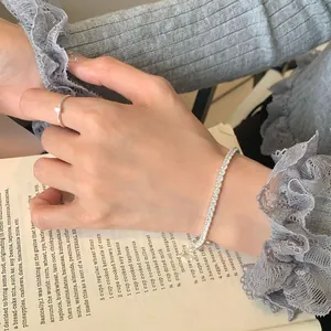 Elegant S925 silver tennis bracelet with sparkling zircon on a vintage book background