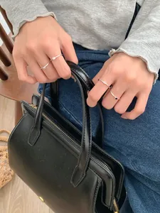Anelli minimalisti in argento sterling S925 con zirconi colorati sulla mano di una modella