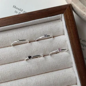 Set di quattro anelli in argento S925 con zirconi colorati in una scatola di legno