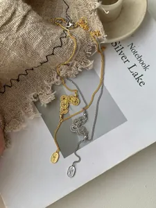 Detail of S925 silver necklaces with gold and silver finishes and Chinese 福 pendants