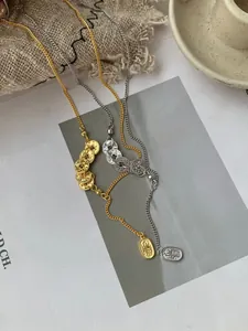 Detailed view of S925 silver ancient coin pendants on gold and silver dainty chains