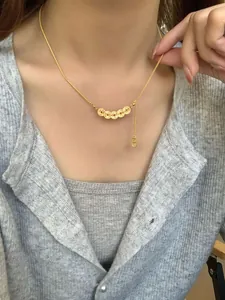 Detail of S925 silver gold coin necklace with traditional Chinese five-coin pendant design