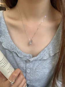 Close-up of S925 sterling silver gourd necklace and adjustable ring on a model
