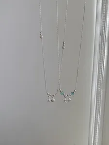 Close-up of S925 silver necklaces with starfish, shell pendants and blue ocean beads