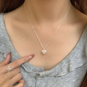 Elegant S925 silver bow necklace and ring set with sparkling diamonds worn by a model