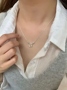 Detailed view of S925 silver necklace with starfish, seashell, and blue beads on a model