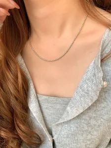 Detailed close-up of a delicate S925 sterling silver bead necklace worn on the neck