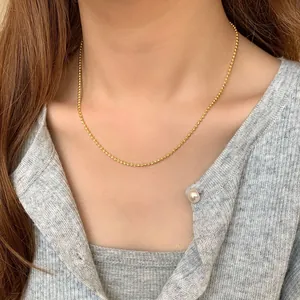 S925 sterling silver beaded ball necklace in gold finish shown on model's neckline