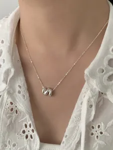 Détail du collier S925 en argent sterling à anneaux ondulés porté sur un mannequin