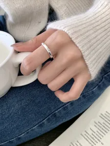 Close-up of minimalist S925 sterling silver ring with textured stardust finish on finger