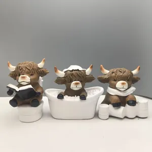 Three Highland Cow figurines for bathroom decor featuring toilet and bathtub scenes